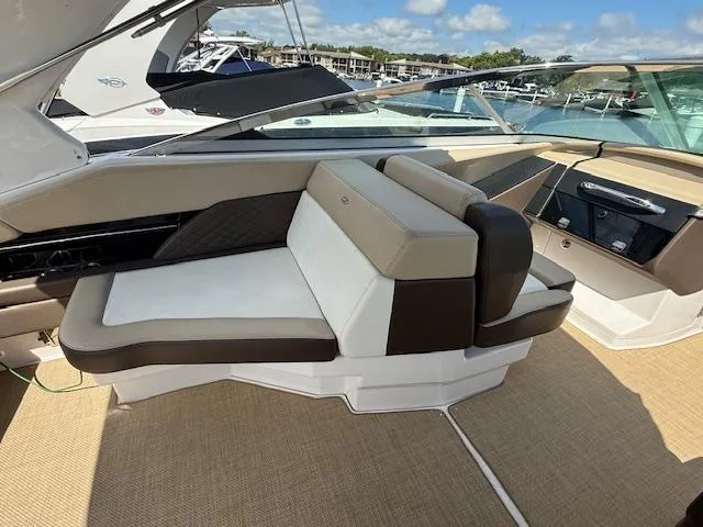 Slide: The Image of 2013 Regal 3200 Bowrider interior with beige seating and sleek design. - 6