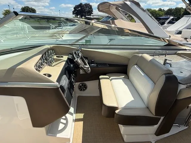 Slide: The Image of 2013 Regal 3200 Bowrider interior with beige seating and modern dashboard controls. - 7