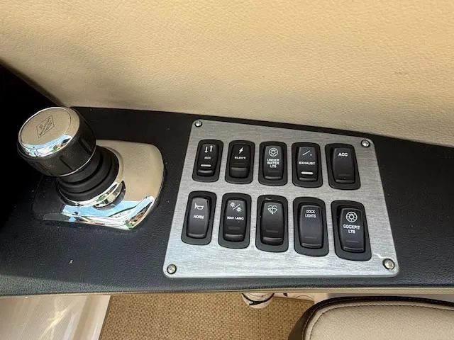 Slide: The Image of Control panel of a 2013 Regal 3200 Bowrider boat with various switches and a knob. - 9