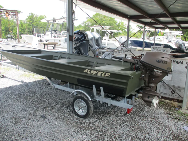 Slide: The Image of 2025 Alweld 1448 DS boat with Yamaha outboard motor on a trailer. - 1