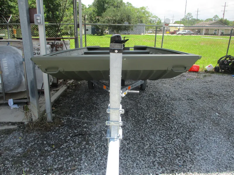 Slide: The Image of 2025 Alweld 1448 DS boat on trailer, parked on gravel near a fence. - 2