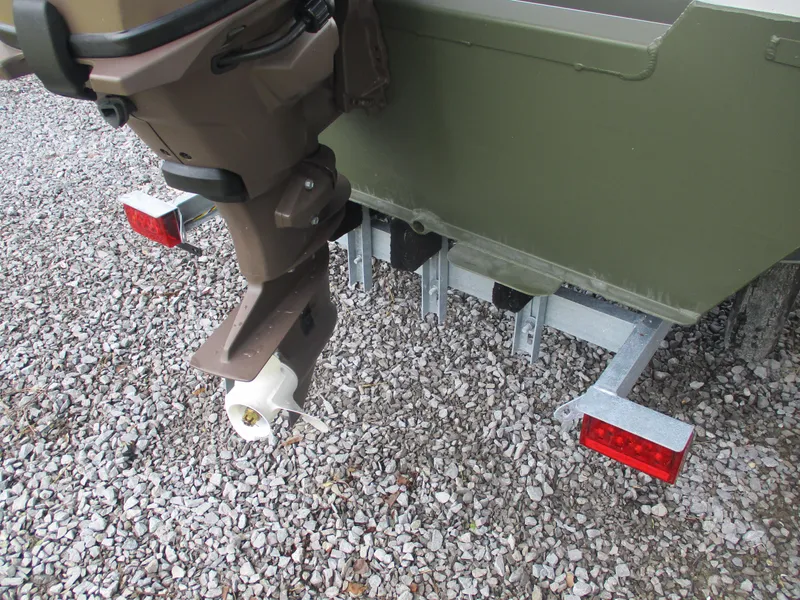 Slide: The Image of 2025 Alweld 1448 DS boat with motor and trailer on gravel surface. - 3