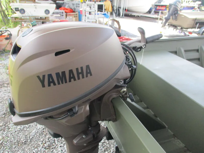 Slide: The Image of 2025 Alweld 1448 DS boat with Yamaha outboard motor in a storage area. - 7
