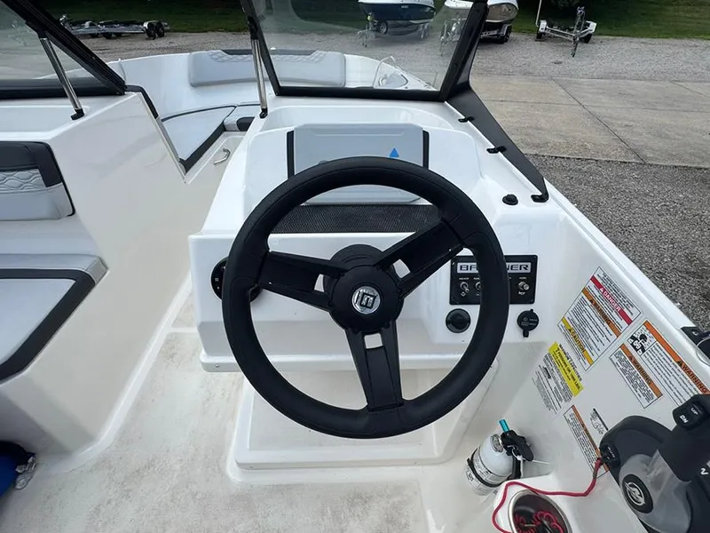 Slide: The Image of 2023 Bayliner Element M17 boat dashboard with steering wheel and controls. - 10