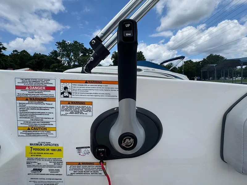Slide: The Image of Throttle control of 2023 Bayliner Element M17 boat with safety warnings and capacity details. - 11