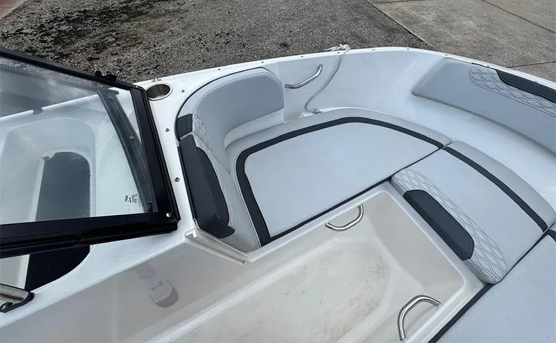 Slide: The Image of 2023 Bayliner Element M17 boat interior with cushioned seating and storage area. - 14