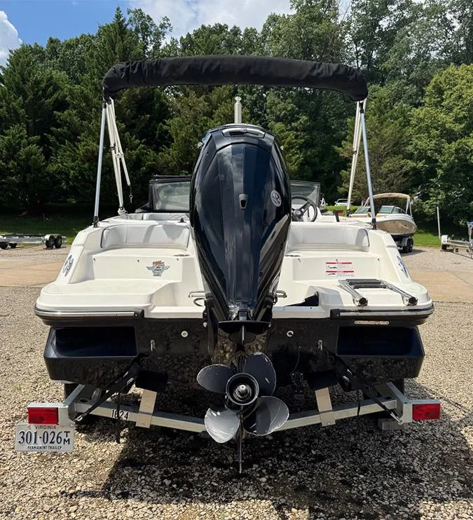 Slide: The Image of 2023 Bayliner Element M17 boat on trailer, rear view with outboard motor. - 2
