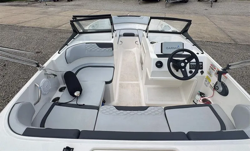 Slide: The Image of 2023 Bayliner Element M17 boat interior with seating, steering wheel, and Garmin navigation system. - 6