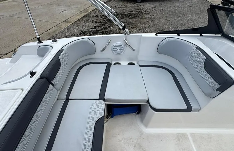 Slide: The Image of 2023 Bayliner Element M17 boat interior with cushioned seating and cup holders. - 8