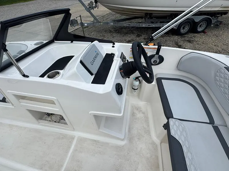 Slide: The Image of 2023 Bayliner Element M17 boat interior with Garmin navigation system and seating. - 9