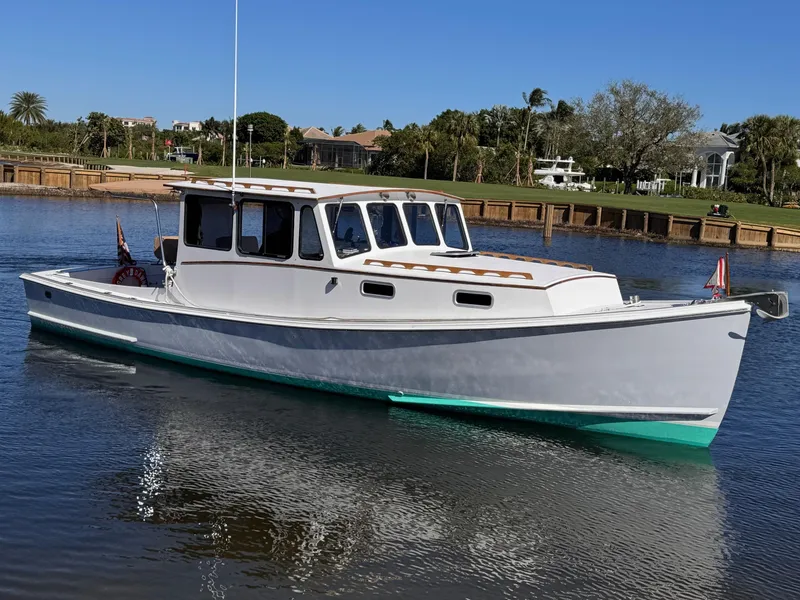 Slide: The Image of 1987 West Bay James Beal 31 Hardtop Lobster Boat on calm water, scenic background. - 14