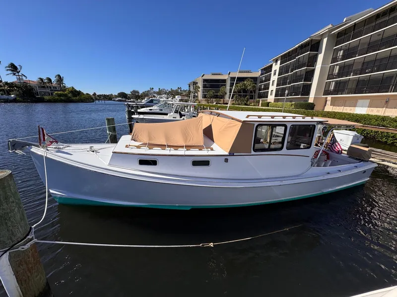 Slide: The Image of 1987 West Bay James Beal 31 Hardtop Lobster Boat docked in a sunny marina. - 15