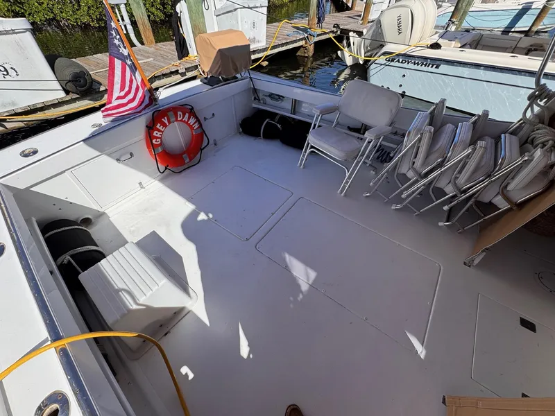 Slide: The Image of 1987 West Bay James Beal 31 Hardtop Lobster Boat deck with chairs and life preserver. - 16