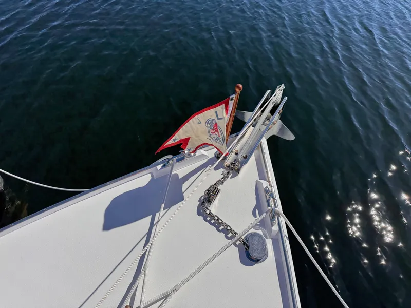 Slide: The Image of Bow of 1987 West Bay James Beal 31 Lobster Boat with flag and anchor chain. - 17