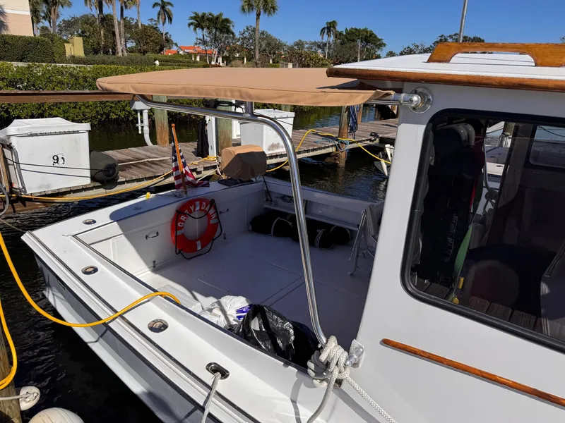 Slide: The Image of 1987 West Bay James Beal 31 Hardtop Lobster Boat docked, featuring a shaded deck area. - 20