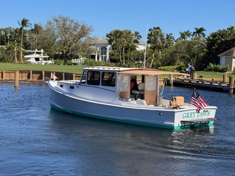 Slide: The Image of 1987 West Bay James Beal 31 Hardtop Lobster Boat on calm water, named "Grey Dawn." - 23