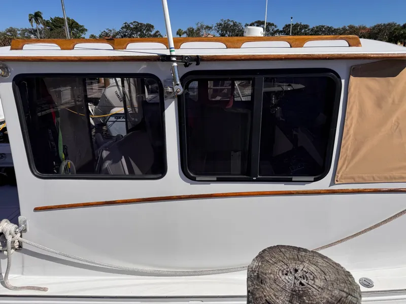 Slide: The Image of 1987 West Bay James Beal 31 Hardtop Lobster Boat side view with windows and wooden trim. - 8