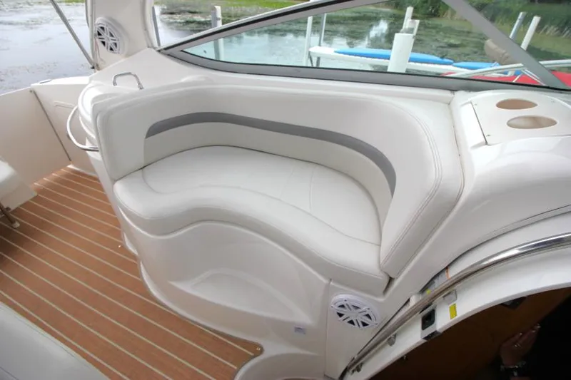 Slide: The Image of 2006 Chaparral Signature 290 boat interior with white seating and wood flooring. - 10