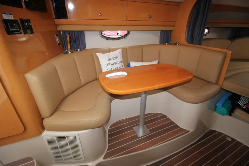 Slide: The Image of 2006 Chaparral Signature 290 interior with cozy seating and wooden table. - 15