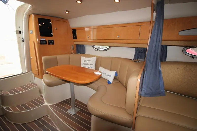 Slide: The Image of Interior of 2006 Chaparral Signature 290 boat with cozy seating and wooden table. - 16