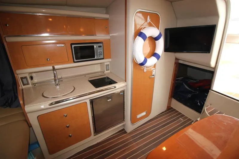 Slide: The Image of 2006 Chaparral Signature 290 interior with kitchenette, microwave, and life preserver. - 18