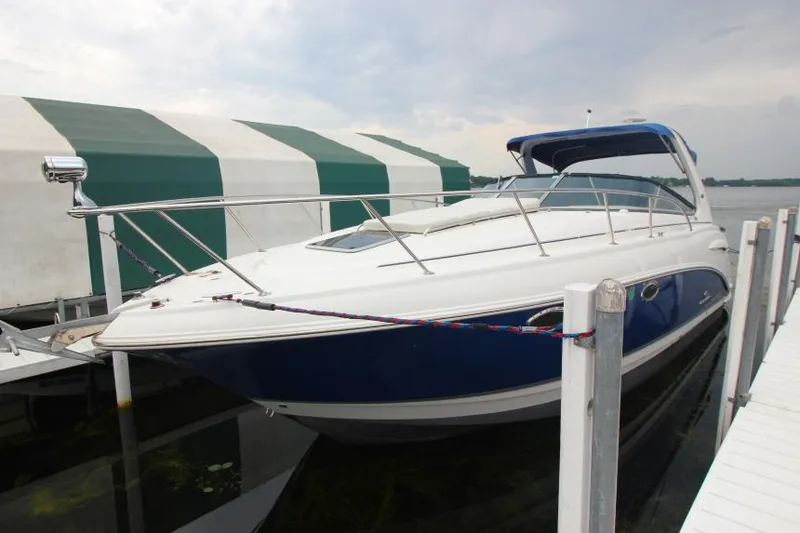 Slide: The Image of 2006 Chaparral Signature 290 boat docked with blue and white exterior. - 2