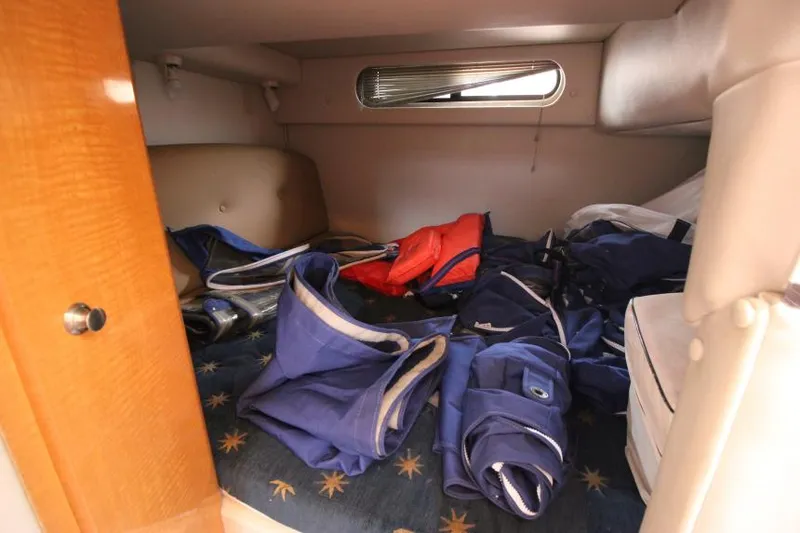 Slide: The Image of 2006 Chaparral Signature 290 cabin storage with life jackets and gear. - 21