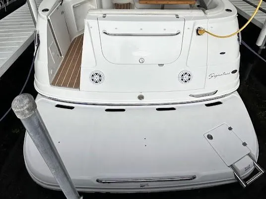 Slide: The Image of 2006 Chaparral Signature 290 boat stern view with swim platform and dock connection. - 4