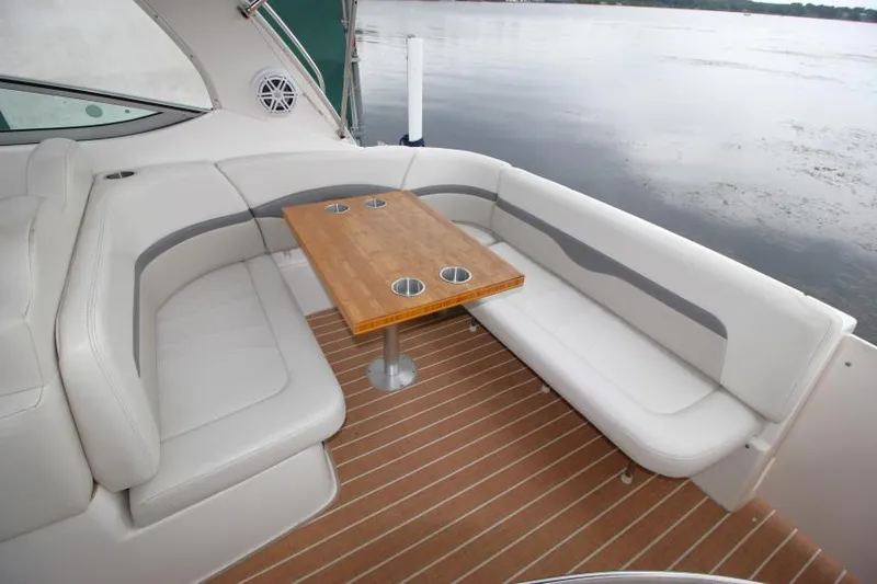 Slide: The Image of 2006 Chaparral Signature 290 boat interior with white seating and wooden table. - 6