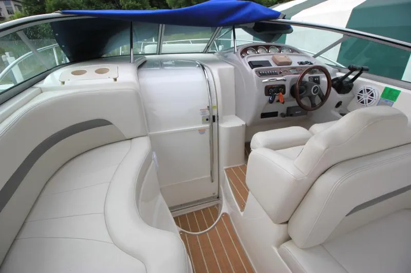 Slide: The Image of 2006 Chaparral Signature 290 boat interior with white seating and wood accents. - 9