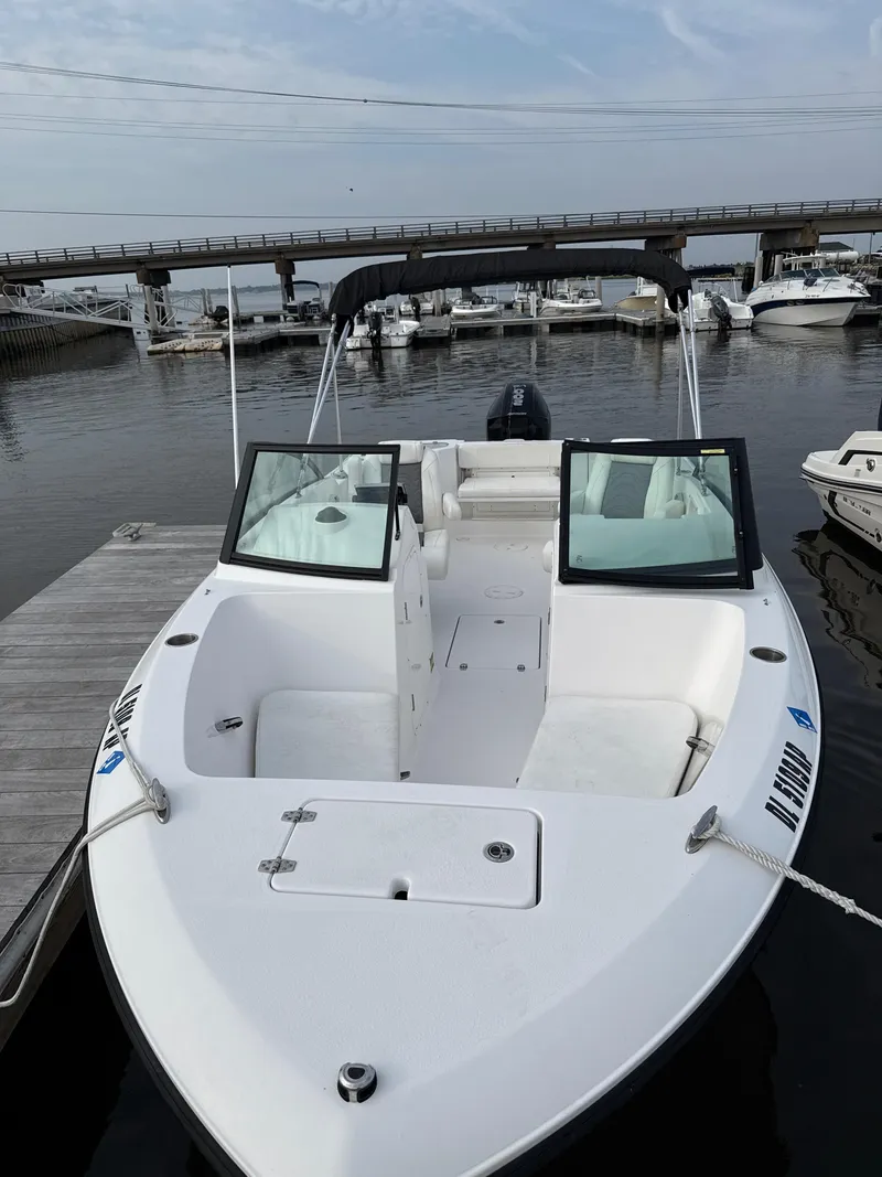 Slide: The Image of 2024 Aquasport 2200 Dual Console boat docked at marina. - 3