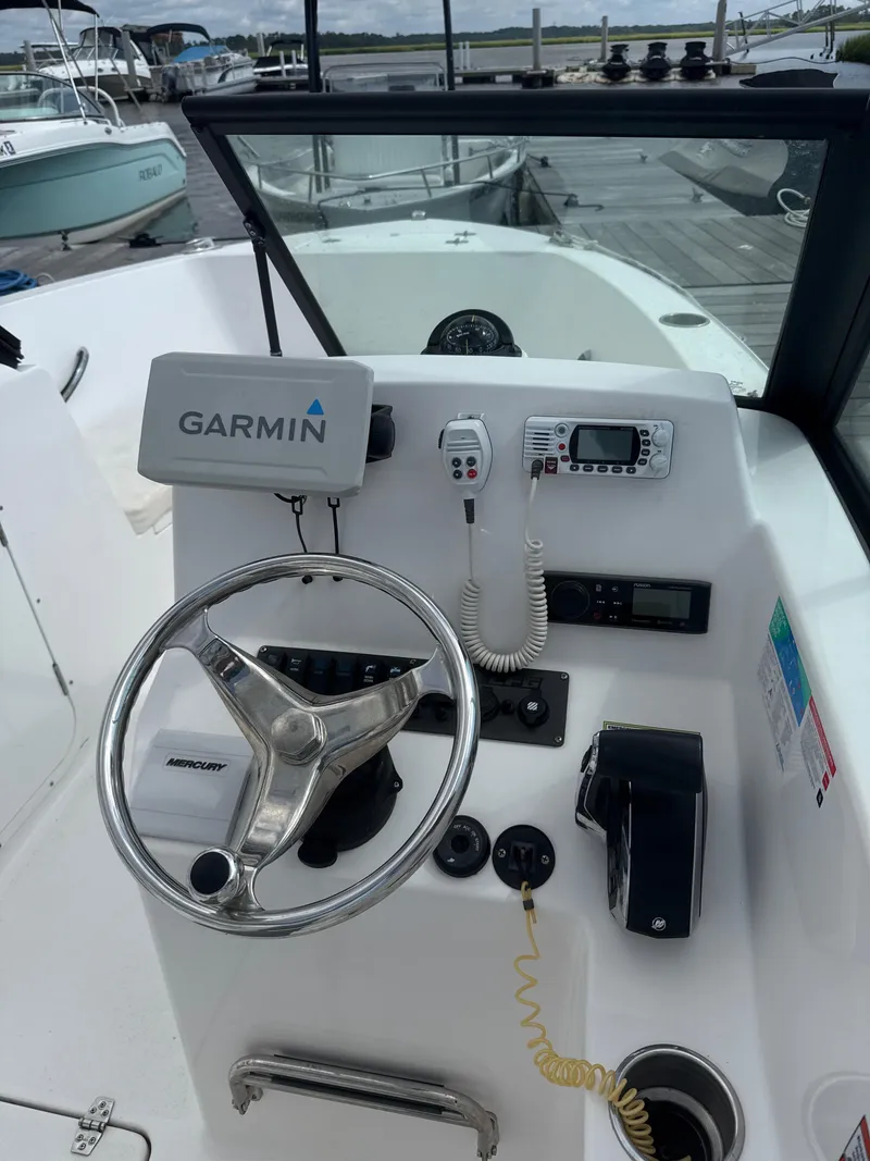 Slide: The Image of 2024 Aquasport 2200 Dual Console boat dashboard with Garmin navigation system. - 6