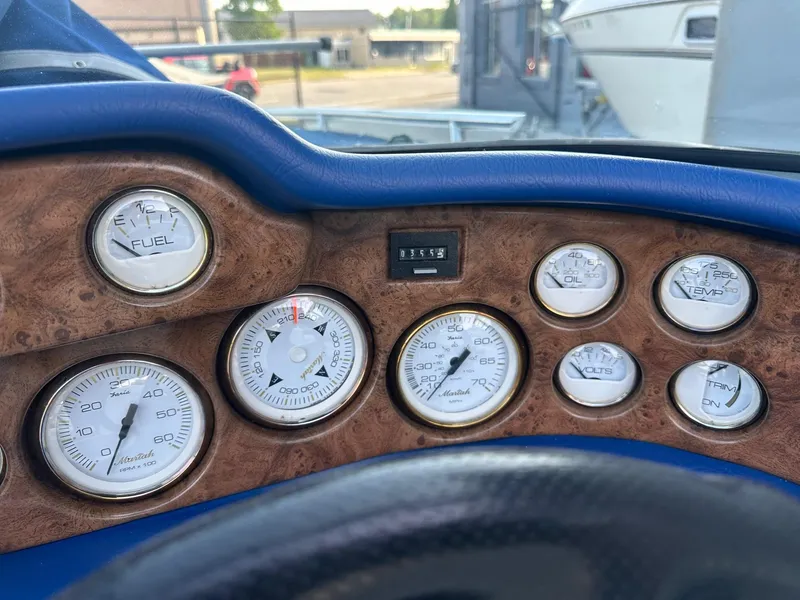 Slide: The Image of Dashboard of a 1998 Mariah Z222 Shabah boat with various gauges and controls. - 4
