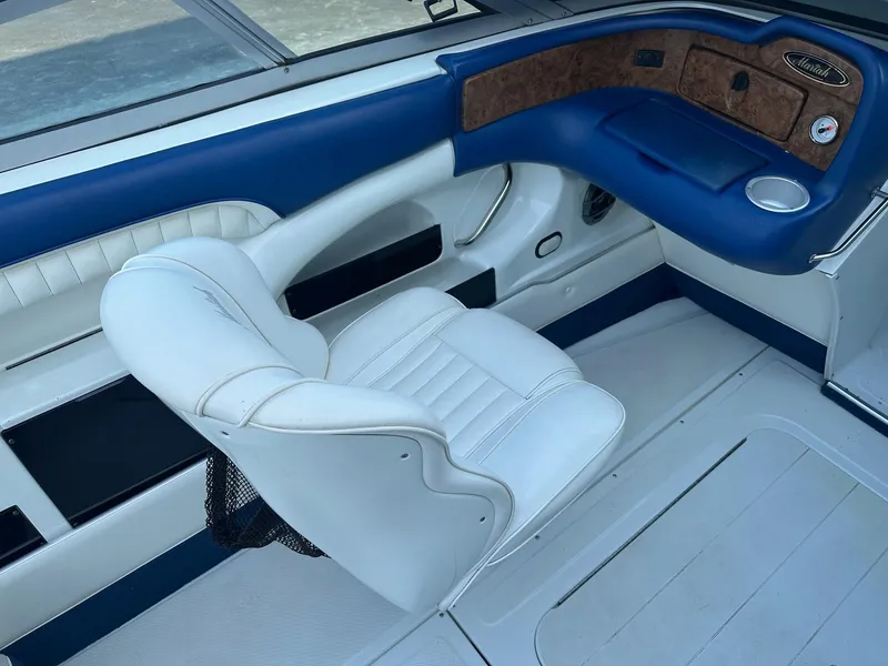 Slide: The Image of Interior of 1998 Mariah Z222 Shabah boat with white and blue seating. - 5