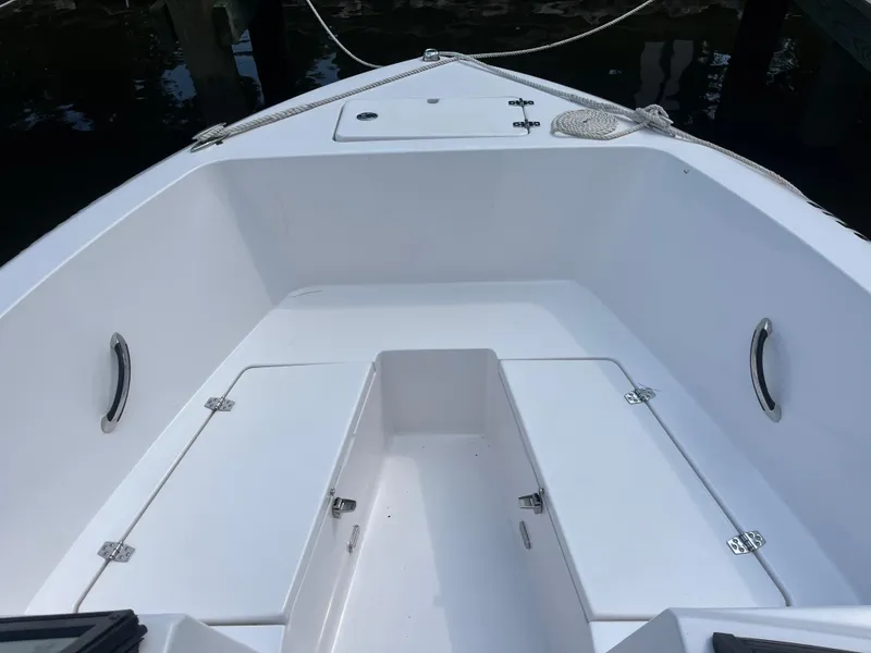 Slide: The Image of 2024 Aquasport 2200 Dual Console boat interior with storage compartments and grab handles. - 3
