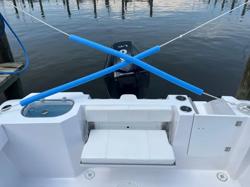 Slide: The Image of 2024 Aquasport 2200 Dual Console boat with seating and motor at dock. - 4