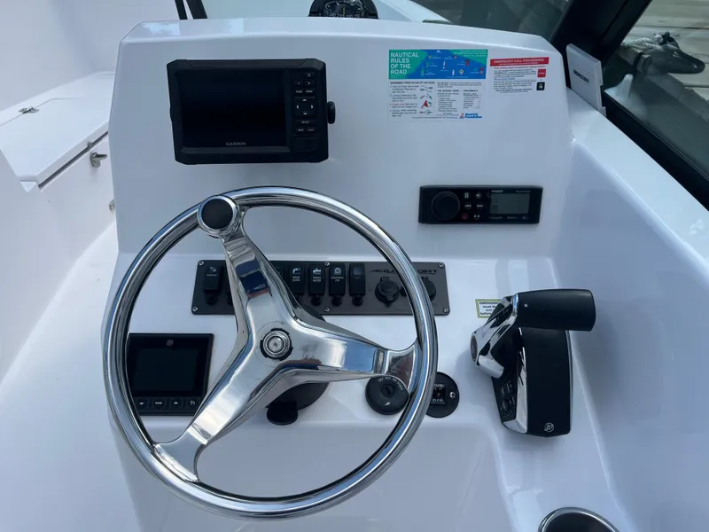 Slide: The Image of 2024 Aquasport 2200 Dual Console dashboard with steering wheel and navigation controls. - 5