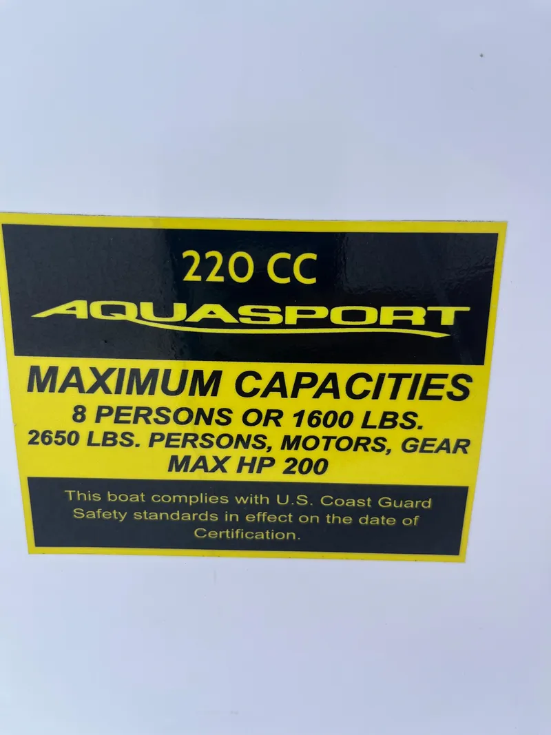 Slide: The Image of 2024 Aquasport 2200 Dual Console capacity label: 8 people, 1600 lbs, max 200 HP. - 7