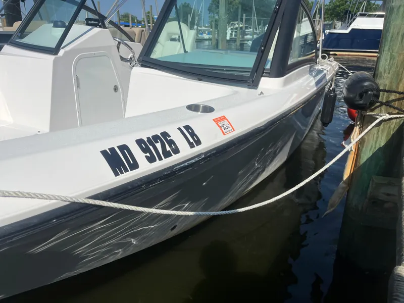 Slide: The Image of 2024 Aquasport 2200 Dual Console boat docked in marina. - 4