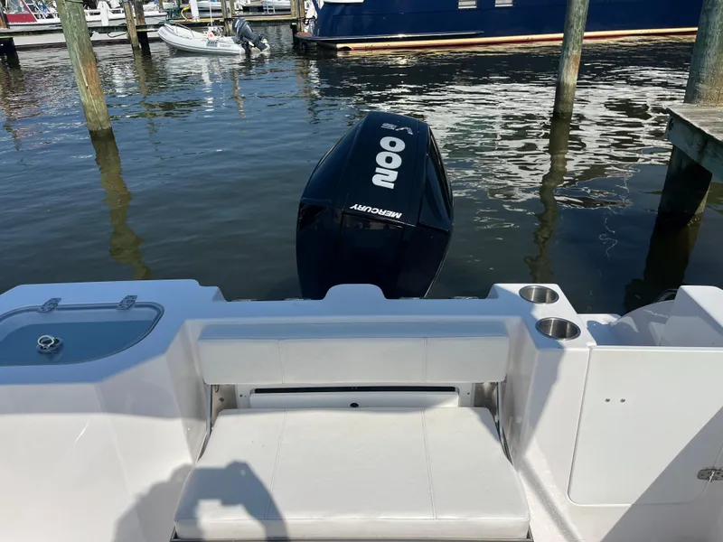 Slide: The Image of 2024 Aquasport 2200 Dual Console boat with Mercury 200 engine at dock. - 9