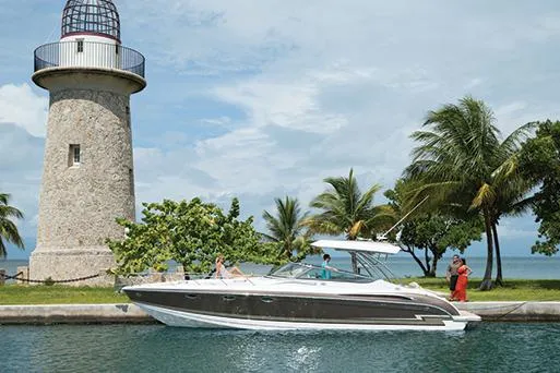 Slide: The Image of Manufacturer Provided Image: 2015 Formula 370 Super Sport boat near a lighthouse and palm trees. - 4