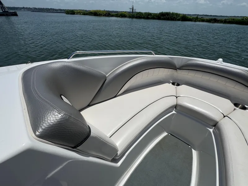 Slide: The Image of 2007 Yamaha AR230 HO boat interior with gray seating, on a calm lake. - 11