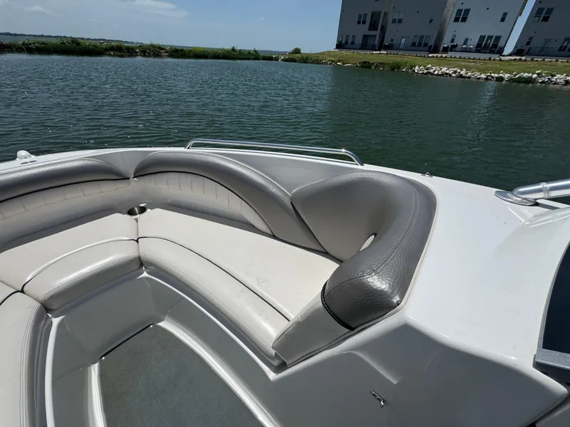 Slide: The Image of 2007 Yamaha AR230 HO boat interior with cushioned seating on a calm lake. - 12