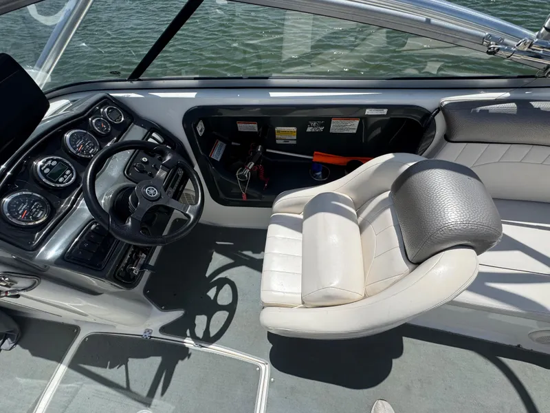 Slide: The Image of 2007 Yamaha Boats AR230 HO cockpit with steering wheel and gauges, overlooking water. - 14
