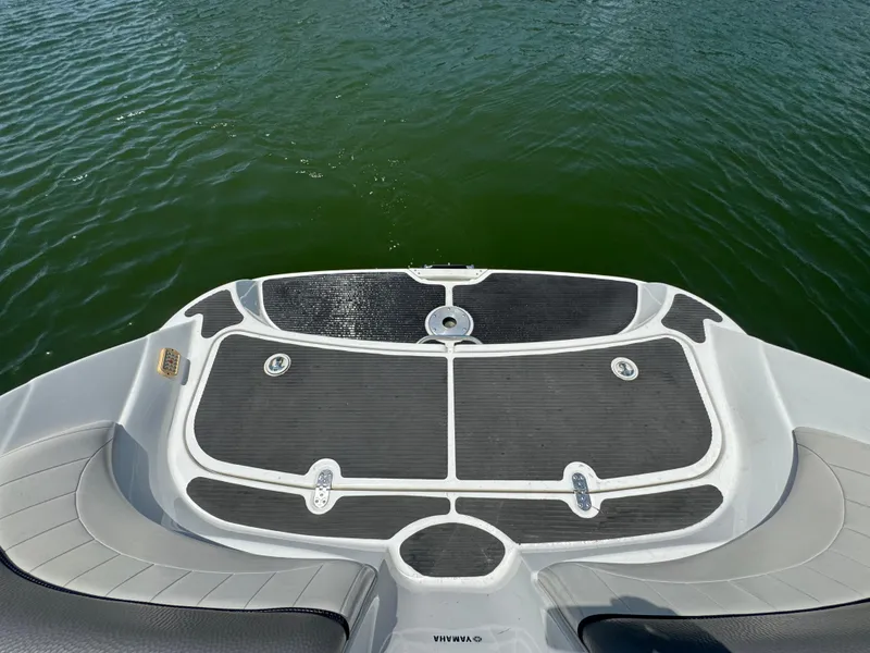Slide: The Image of 2007 Yamaha AR230 HO boat swim platform with black mat, overlooking green water. - 19