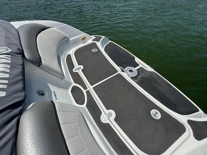 Slide: The Image of 2007 Yamaha AR230 HO boat deck with cushioned seating, near water. - 22