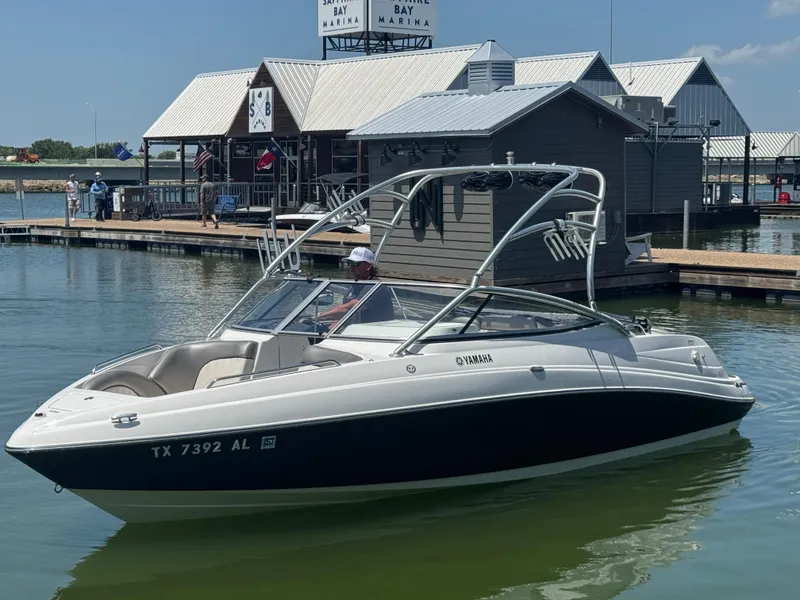 Slide: The Image of 2007 Yamaha AR230 HO boat docked at a marina under a clear blue sky. - 4