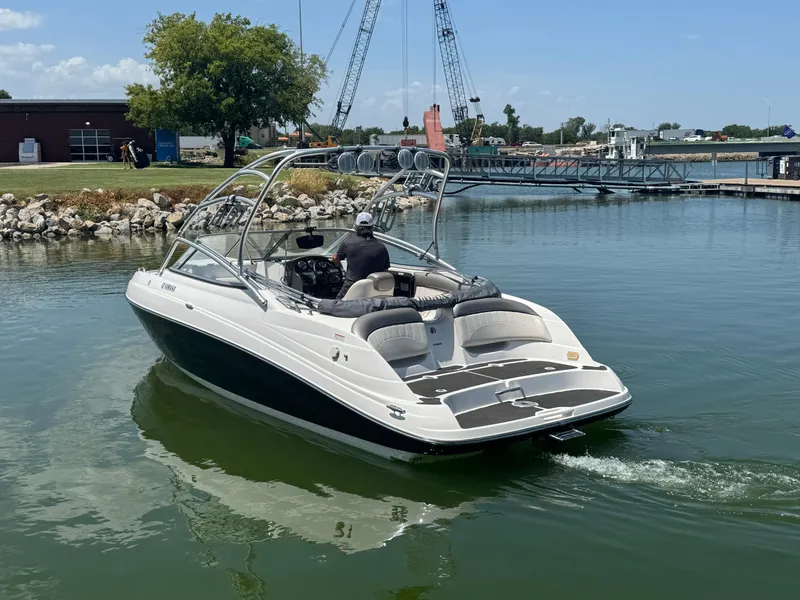 Slide: The Image of 2007 Yamaha AR230 HO boat cruising near a dock on a sunny day. - 5
