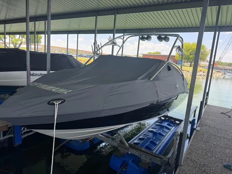 Slide: The Image of 2007 Yamaha AR230 HO boat covered and docked in a marina. - 6