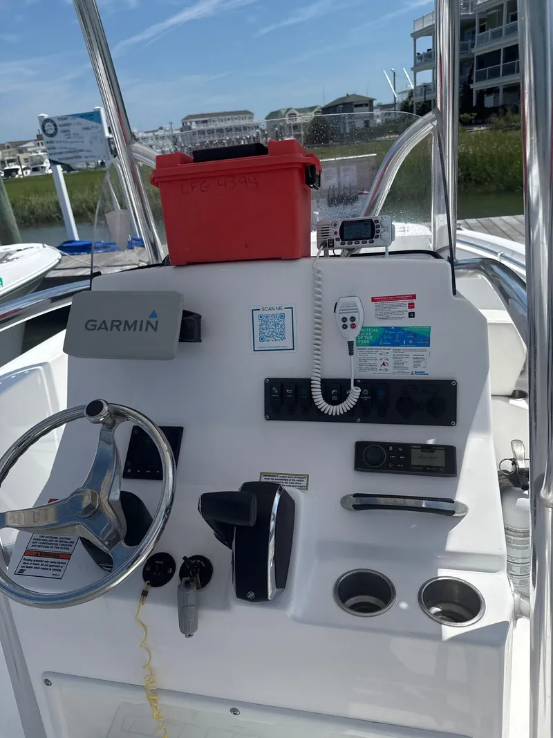 Slide: The Image of 2023 Aquasport 2200 Center Console boat dashboard with Garmin navigation system. - 7